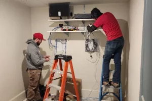 men running wiring through wall